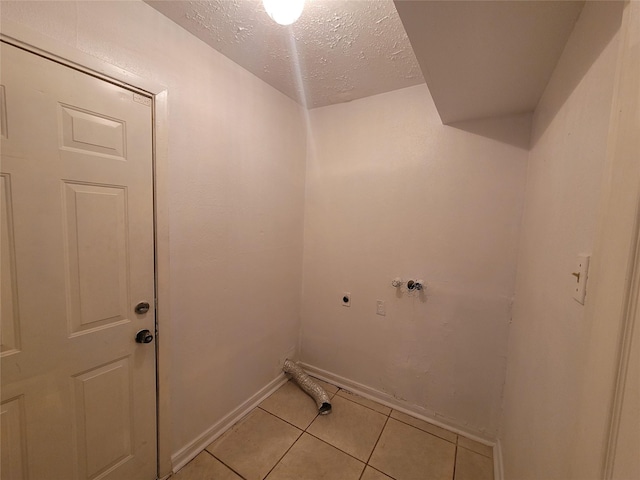 13930 New Village Ln, Sugar Land, TX 77498 - washroom featuring electric dryer hookup, light tile patterned floors, a textured ceiling, and hookup for a washing machine