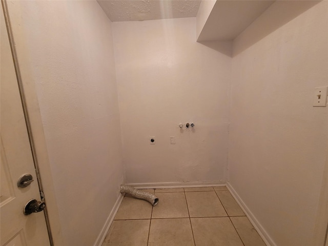 13930 New Village Ln, Sugar Land, TX 77498 - laundry area with hookup for an electric dryer, light tile patterned floors, washer hookup, and a textured ceiling
