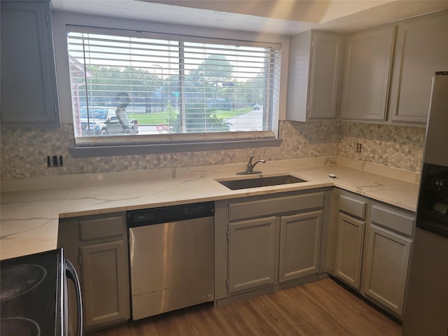 13930 New Village Ln, Sugar Land, TX 77498 - kitchen featuring appliances with stainless steel finishes, dark wood-style floors, gray cabinets, and light stone countertops