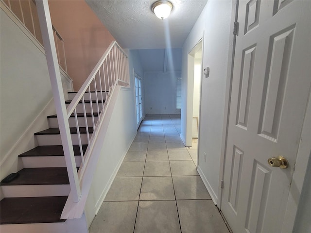 13930 New Village Ln, Sugar Land, TX 77498 - stairway featuring tile patterned floors and a textured ceiling