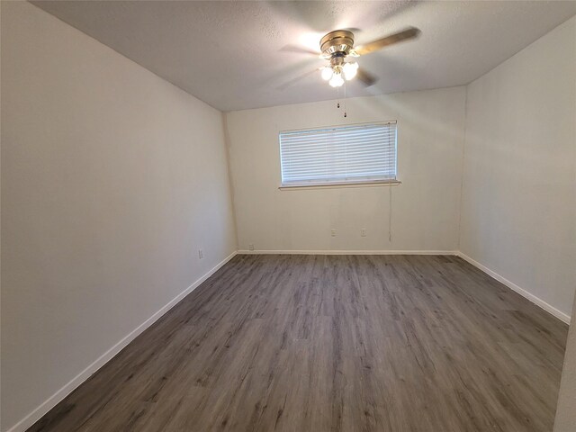 13930 New Village Ln, Sugar Land, TX 77498 - empty room featuring ceiling fan, dark wood finished floors, and a textured ceiling