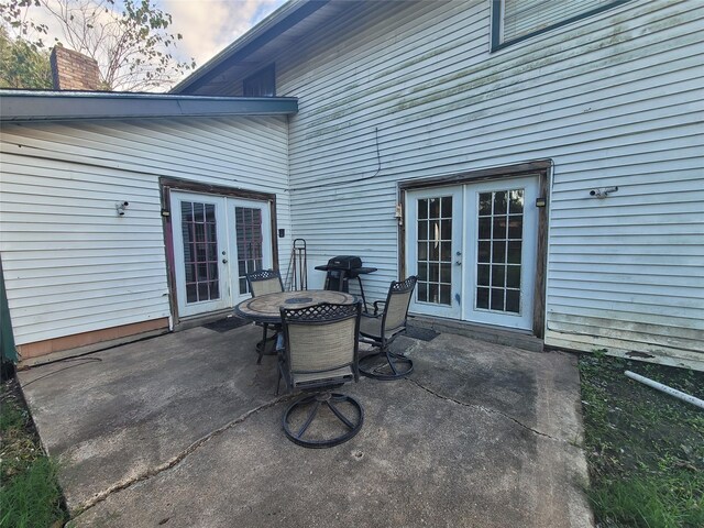 13930 New Village Ln, Sugar Land, TX 77498 - view of patio / terrace featuring french doors and outdoor dining area
