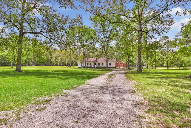456 Cheatham Rd, Huffman, TX 77336 - view of front of property featuring a front lawn, driveway, view of wooded area, and a barn