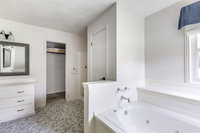 456 Cheatham Rd, Huffman, TX 77336 - full bath featuring a jetted tub, vanity, tile patterned floors, and a textured ceiling