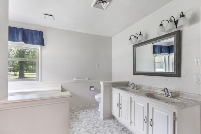 456 Cheatham Rd, Huffman, TX 77336 - full bathroom with double vanity and a textured ceiling