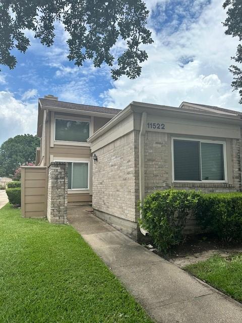 11522 Village Place Dr Unit 81, Houston, TX 77077 - view of front of house featuring a front lawn and brick siding