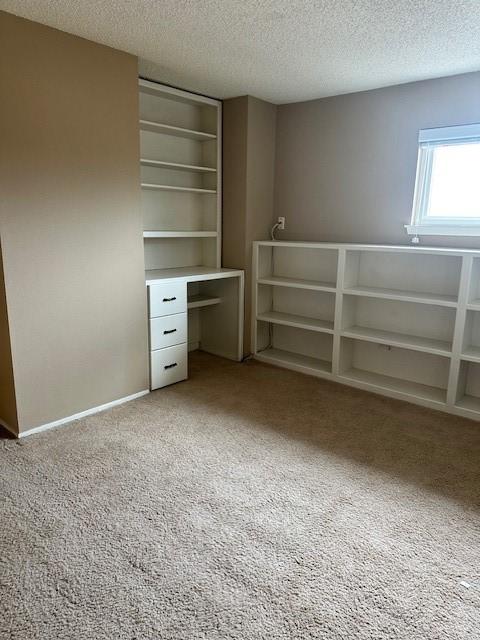 11522 Village Place Dr Unit 81, Houston, TX 77077 - unfurnished bedroom with light colored carpet and a textured ceiling