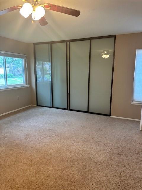 11522 Village Place Dr Unit 81, Houston, TX 77077 - unfurnished bedroom with light carpet, ceiling fan, and a closet