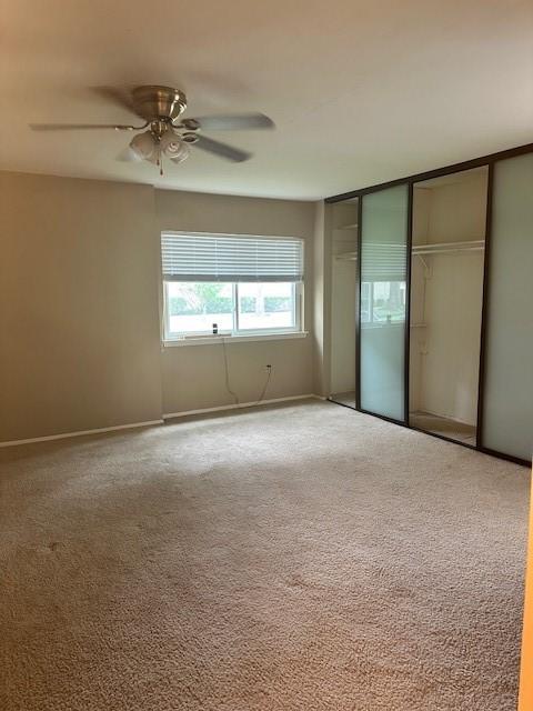 11522 Village Place Dr Unit 81, Houston, TX 77077 - unfurnished bedroom with carpet floors, a closet, and a ceiling fan
