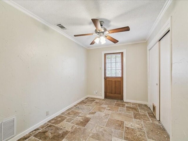 9327 Willowview Ln, Houston, TX 77080 - doorway to outside with stone tile floors, a textured ceiling, a ceiling fan, and crown molding