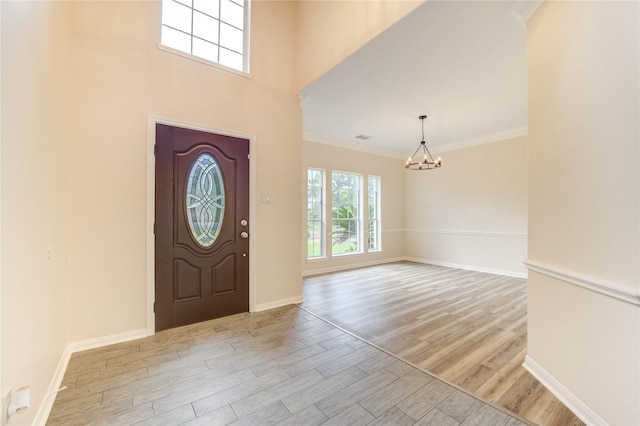 4202 Maurice Way, Stafford, TX 77477 - foyer with a chandelier, light wood-style floors, and crown molding