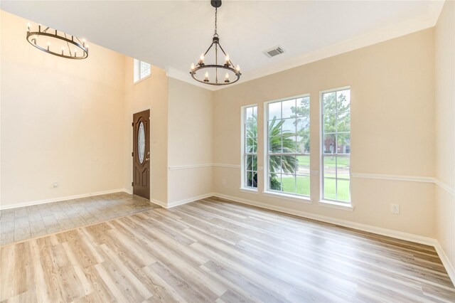 4202 Maurice Way, Stafford, TX 77477 - empty room with a chandelier, plenty of natural light, and wood finished floors