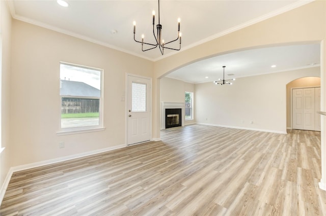 4202 Maurice Way, Stafford, TX 77477 - unfurnished living room featuring a chandelier, arched walkways, light wood-type flooring, a fireplace, and recessed lighting