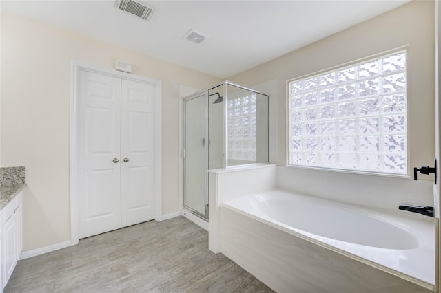4202 Maurice Way, Stafford, TX 77477 - bathroom featuring a garden tub, a stall shower, plenty of natural light, and vanity