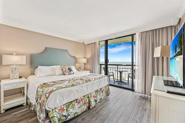 5220 Seawall Blvd Unit 1133C, Galveston, TX 77551 - bedroom with floor to ceiling windows, wood finished floors, access to exterior, and ornamental molding