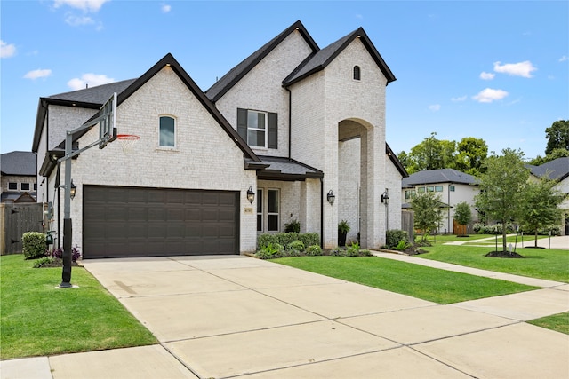 4710 Pecos Ridge Ln, Sugar Land, TX 77479 - french country home with an attached garage, brick siding, and driveway
