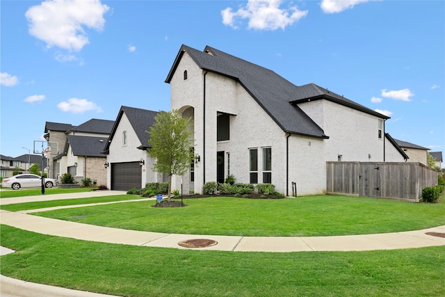 4710 Pecos Ridge Ln, Sugar Land, TX 77479 - french country style house with brick siding, driveway, and a shingled roof