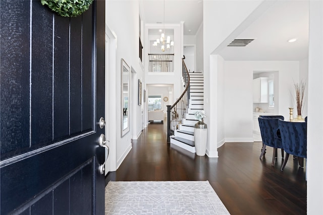 4710 Pecos Ridge Ln, Sugar Land, TX 77479 - foyer entrance featuring dark wood-type flooring, a chandelier, stairway, and healthy amount of natural light
