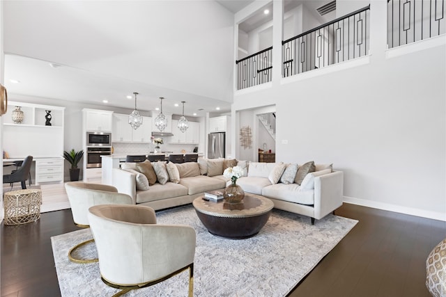 4710 Pecos Ridge Ln, Sugar Land, TX 77479 - living area with dark wood-style flooring, a towering ceiling, and recessed lighting