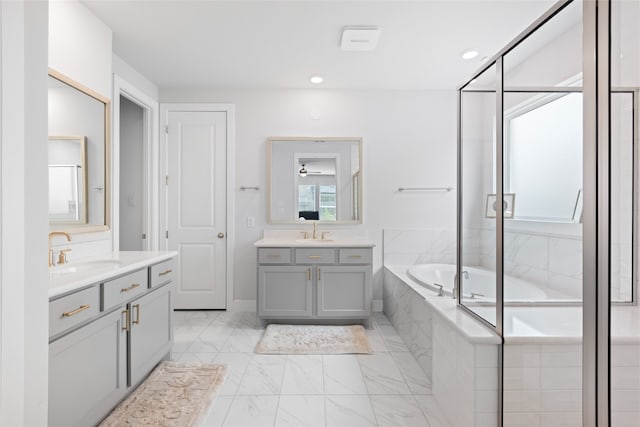 4710 Pecos Ridge Ln, Sugar Land, TX 77479 - bathroom featuring two vanities, a garden tub, and marble finish flooring