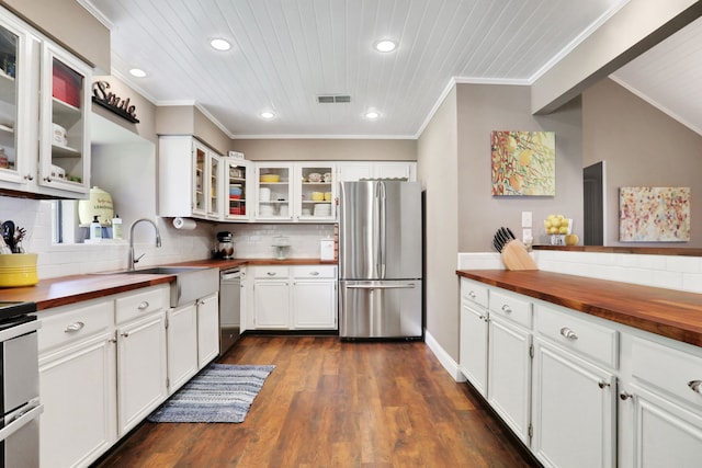 221 Kings Way, Coldspring, TX 77331 - kitchen featuring wood counters, stainless steel appliances, recessed lighting, dark wood finished floors, and decorative backsplash