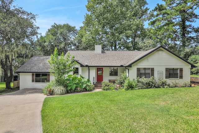 221 Kings Way, Coldspring, TX 77331 - ranch-style home with driveway, a chimney, a front yard, a shingled roof, and brick siding