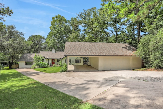221 Kings Way, Coldspring, TX 77331 - ranch-style home featuring driveway, a front lawn, a chimney, and a carport