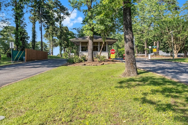 221 Kings Way, Coldspring, TX 77331 - view of front of property with a front lawn and asphalt driveway