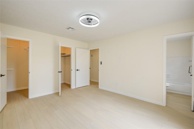 12803 High Star Dr, Houston, TX 77072 - unfurnished bedroom featuring a spacious closet, light wood-type flooring, a closet, and ensuite bathroom