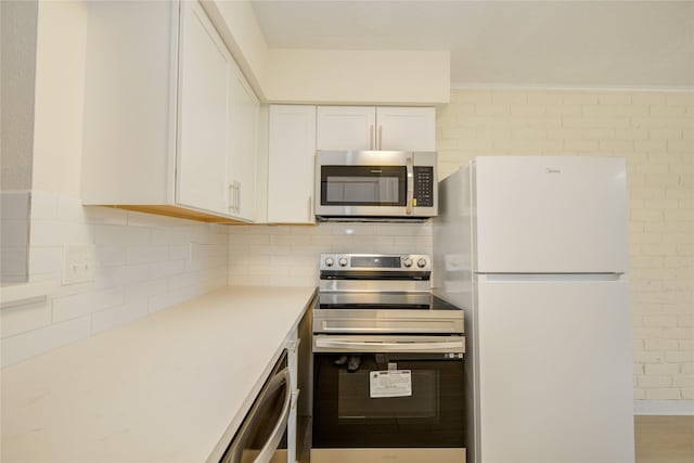 12803 High Star Dr, Houston, TX 77072 - kitchen with stainless steel appliances, white cabinetry, tasteful backsplash, and light countertops