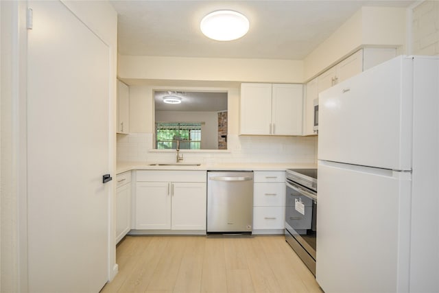 12803 High Star Dr, Houston, TX 77072 - kitchen featuring stainless steel appliances, light countertops, decorative backsplash, and white cabinetry