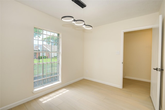 12803 High Star Dr, Houston, TX 77072 - spare room featuring light wood-type flooring and a chandelier