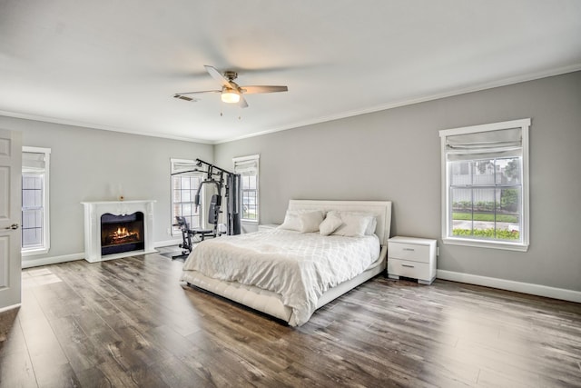248 Wilcrest Dr Unit 248, Houston, TX 77042 - bedroom with a lit fireplace, wood finished floors, ornamental molding, and ceiling fan