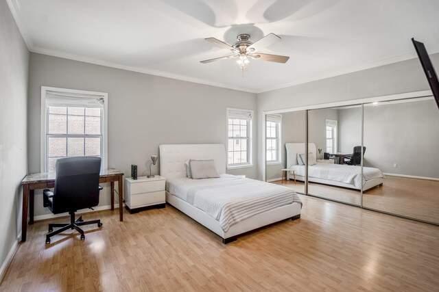 248 Wilcrest Dr Unit 248, Houston, TX 77042 - bedroom featuring an office area, wood finished floors, crown molding, a closet, and a ceiling fan