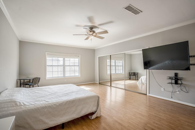 248 Wilcrest Dr Unit 248, Houston, TX 77042 - bedroom featuring ornamental molding, wood finished floors, a closet, and ceiling fan