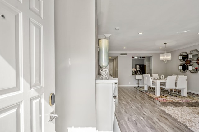 248 Wilcrest Dr Unit 248, Houston, TX 77042 - hall featuring crown molding, light wood-style flooring, recessed lighting, and a chandelier