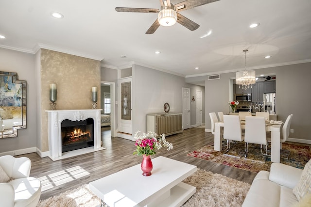 248 Wilcrest Dr Unit 248, Houston, TX 77042 - living area featuring ceiling fan, recessed lighting, wood finished floors, a chandelier, and a warm lit fireplace