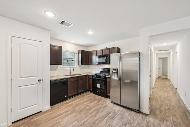 852 Rd 5138, Cleveland, TX 77327 - kitchen with black appliances, light wood-type flooring, dark brown cabinets, and recessed lighting