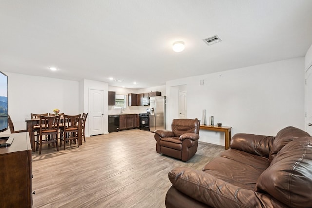 852 Rd 5138, Cleveland, TX 77327 - living room with light wood-type flooring and recessed lighting