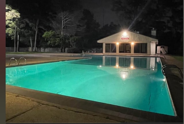5664 Birchmont Dr Unit 4, Houston, TX 77091 - pool at twilight featuring an outdoor pool and a patio area