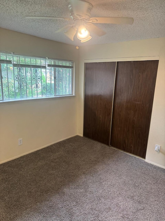 5664 Birchmont Dr Unit 4, Houston, TX 77091 - unfurnished bedroom with carpet, a textured ceiling, a closet, and a ceiling fan