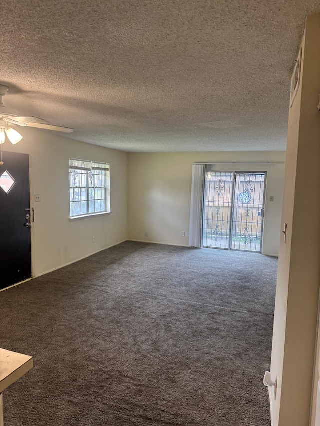 5664 Birchmont Dr Unit 4, Houston, TX 77091 - unfurnished living room with carpet, ceiling fan, and a textured ceiling