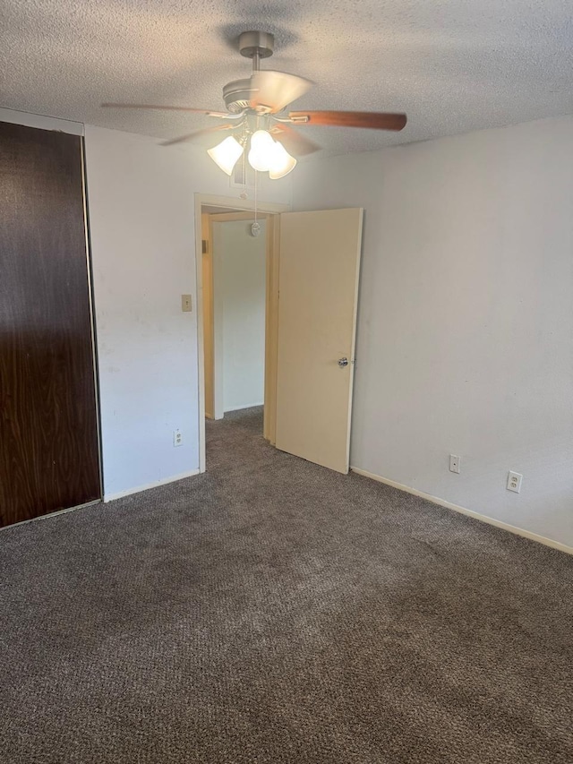 5664 Birchmont Dr Unit 4, Houston, TX 77091 - unfurnished room with dark carpet, ceiling fan, and a textured ceiling