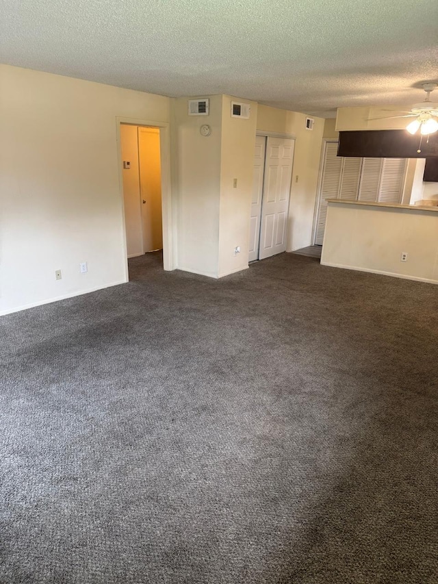 5664 Birchmont Dr Unit 4, Houston, TX 77091 - unfurnished living room with a textured ceiling, a ceiling fan, and dark carpet