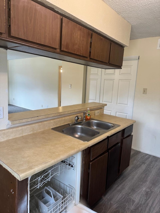 5664 Birchmont Dr Unit 4, Houston, TX 77091 - kitchen with dark wood-style flooring, light countertops, a textured ceiling, and dark brown cabinets