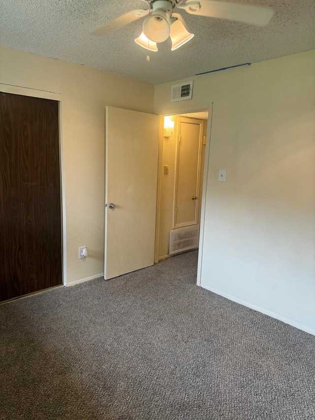5664 Birchmont Dr Unit 4, Houston, TX 77091 - unfurnished bedroom featuring carpet floors, ceiling fan, and a textured ceiling