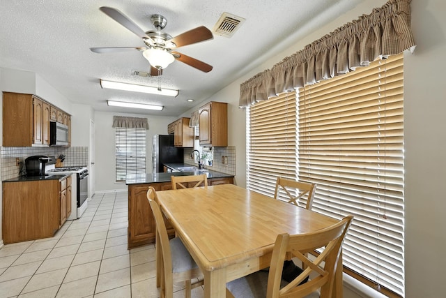 10410 Dude Rd, Houston, TX 77064 - dining room featuring a textured ceiling, light tile patterned floors, and a ceiling fan