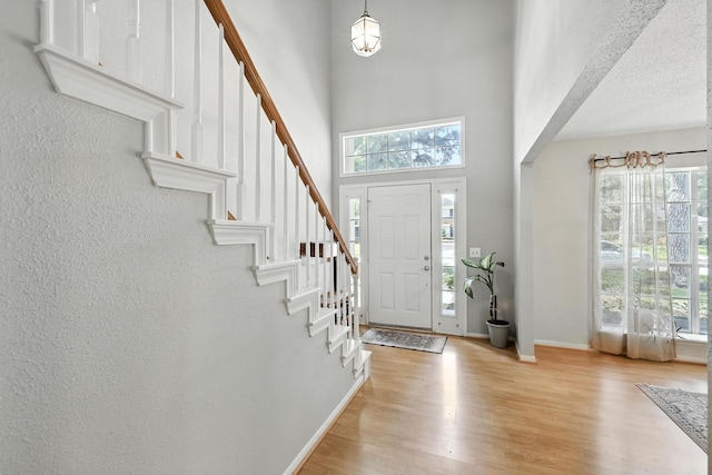 10410 Dude Rd, Houston, TX 77064 - foyer entrance featuring light wood-style flooring, a towering ceiling, and stairs
