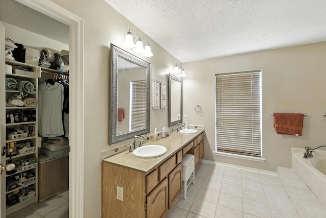10410 Dude Rd, Houston, TX 77064 - full bathroom featuring a textured ceiling, double vanity, tile patterned flooring, a garden tub, and a spacious closet