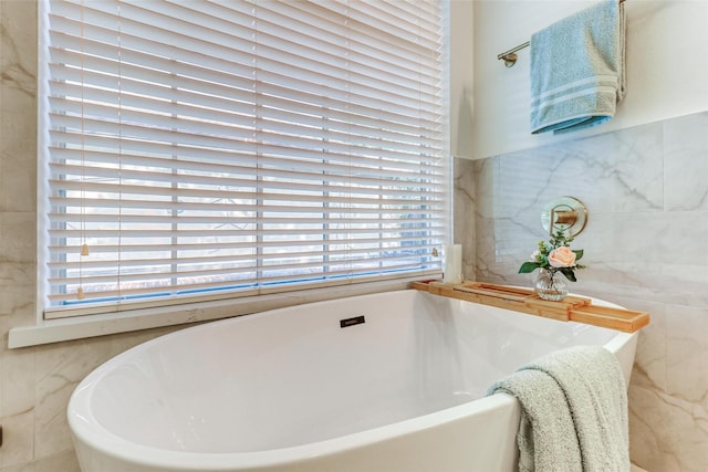 23314 Dunhill Ct, Katy, TX 77494 - bathroom with tile walls and a freestanding bath